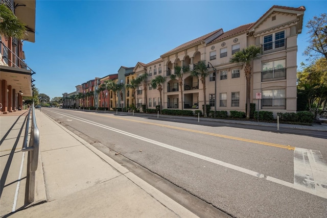 view of street featuring curbs, sidewalks, and a residential view