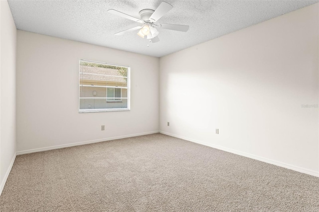 empty room featuring carpet, ceiling fan, and a textured ceiling