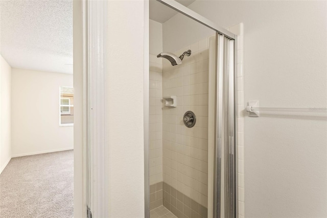 bathroom featuring a textured ceiling and an enclosed shower