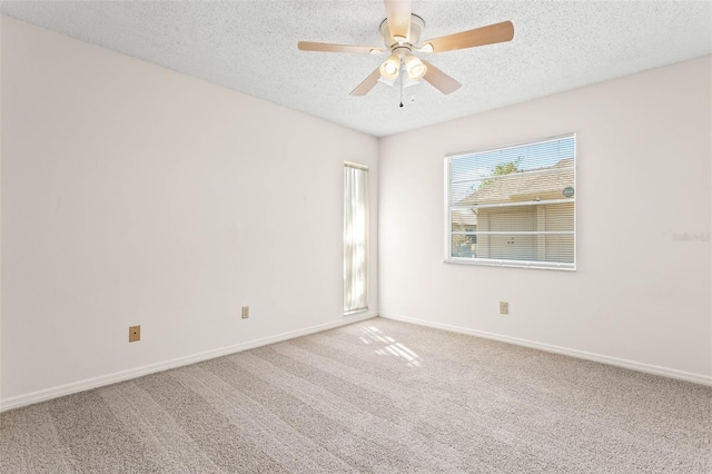 unfurnished room featuring carpet, ceiling fan, and a textured ceiling