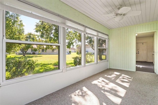 unfurnished sunroom with ceiling fan