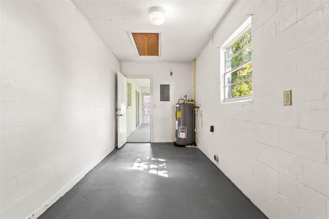 garage featuring water heater and electric panel