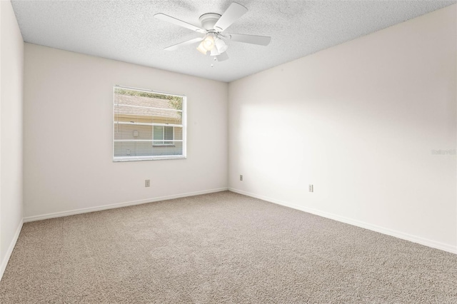 2222 Greenhaven Dr, Sun City Center, FL 33573 - empty room featuring carpet flooring, a textured ceiling, ceiling fan, and baseboards