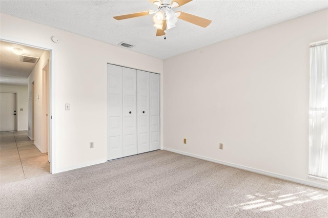 2222 Greenhaven Dr, Sun City Center, FL 33573 - unfurnished bedroom with light colored carpet, baseboards, a closet, and a ceiling fan