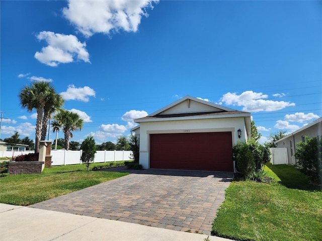 view of front of home featuring a front yard and a garage