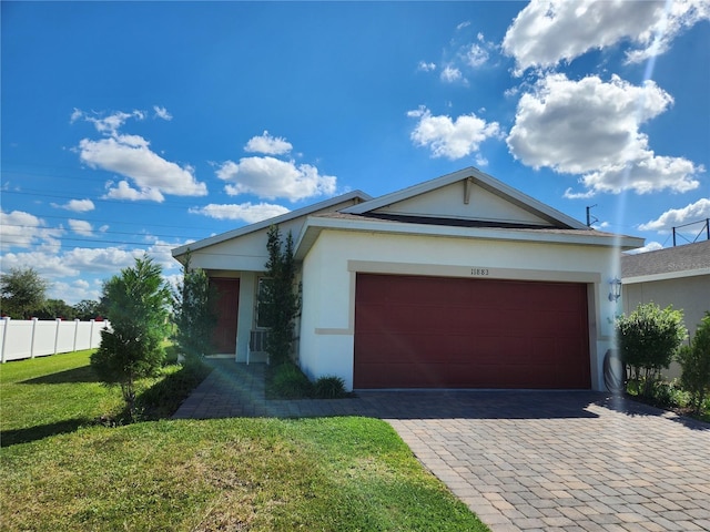 single story home featuring a garage and a front lawn