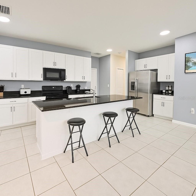 11883 Brighton Knoll Loop, Riverview, FL 33579 - kitchen featuring black appliances, a kitchen breakfast bar, a sink, dark countertops, and white cabinets