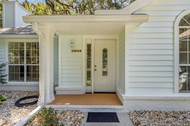 view of exterior entry featuring a porch