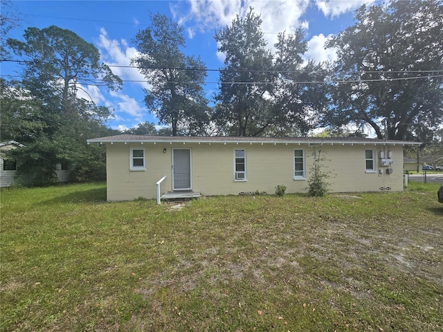 rear view of property with a lawn