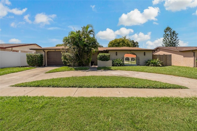 view of front of house featuring a front yard and a garage