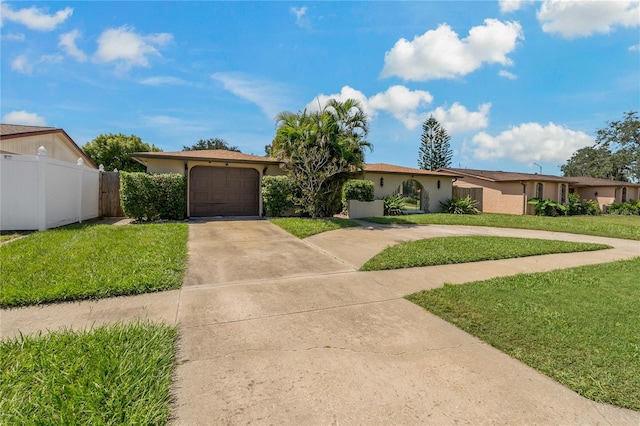 ranch-style home featuring a garage and a front lawn