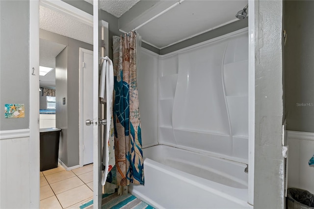 bathroom featuring a textured ceiling, shower / bath combo, and tile patterned flooring