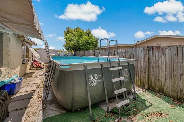 exterior space with a fenced in pool