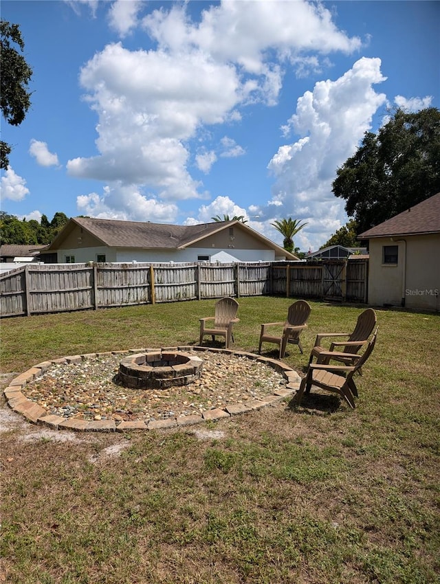 view of yard with an outdoor fire pit