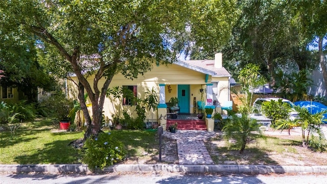 bungalow-style house with a front yard