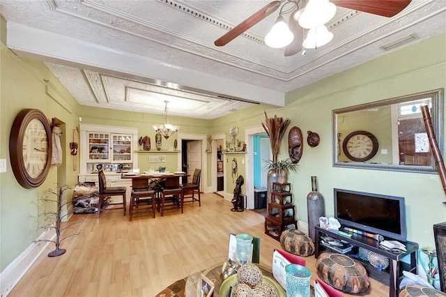 living room featuring beamed ceiling, hardwood / wood-style floors, ceiling fan with notable chandelier, and a textured ceiling