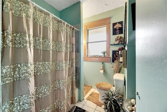 bathroom with a shower with curtain and tile patterned flooring