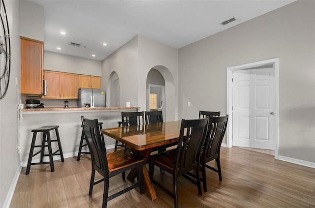 dining space with light hardwood / wood-style flooring