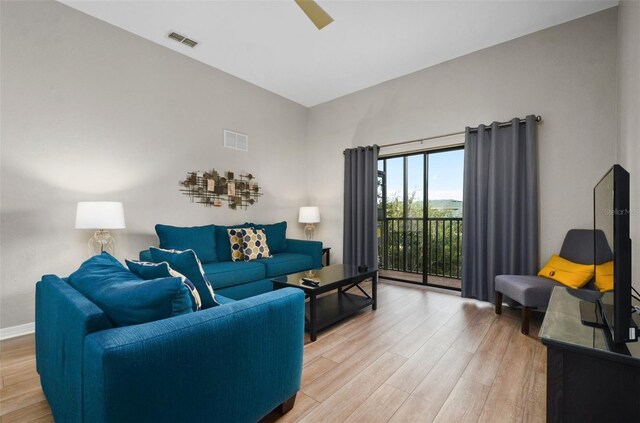 living room with ceiling fan and hardwood / wood-style flooring