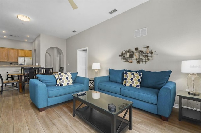 living room featuring ceiling fan and light hardwood / wood-style flooring