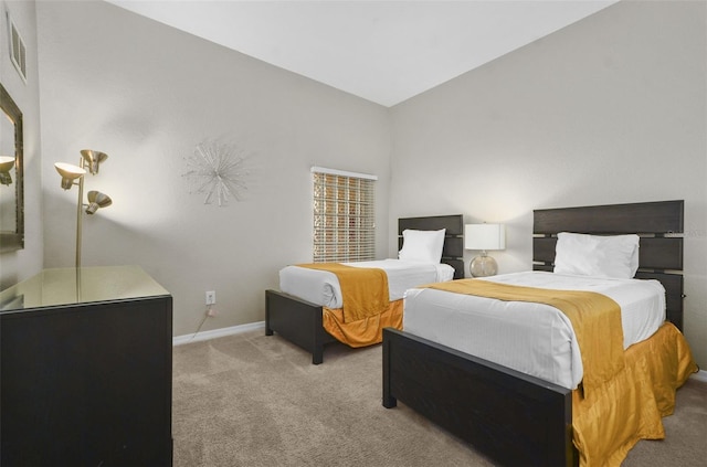 bedroom with lofted ceiling and light colored carpet