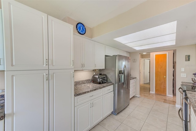 kitchen with white cabinetry, tasteful backsplash, stainless steel appliances, and light tile patterned floors