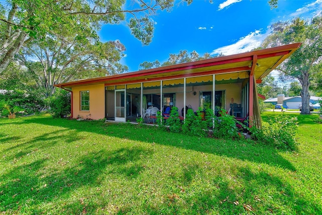 back of house with a yard