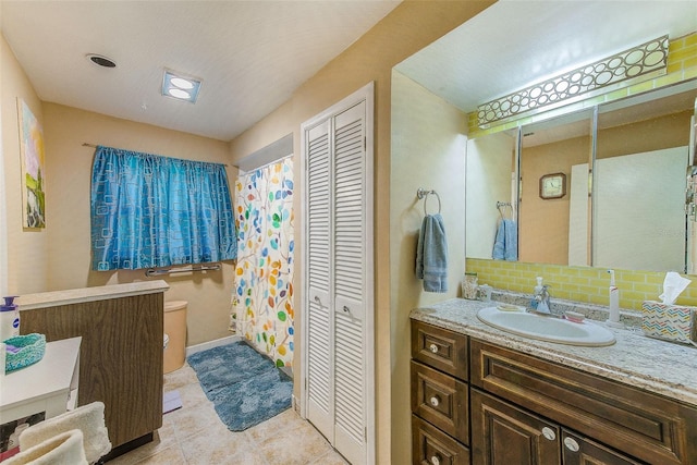 bathroom featuring vanity, tasteful backsplash, and tile patterned floors