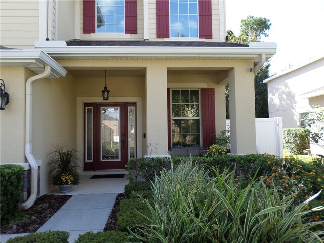 view of exterior entry with covered porch