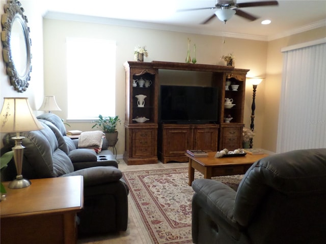 living room with ceiling fan and ornamental molding