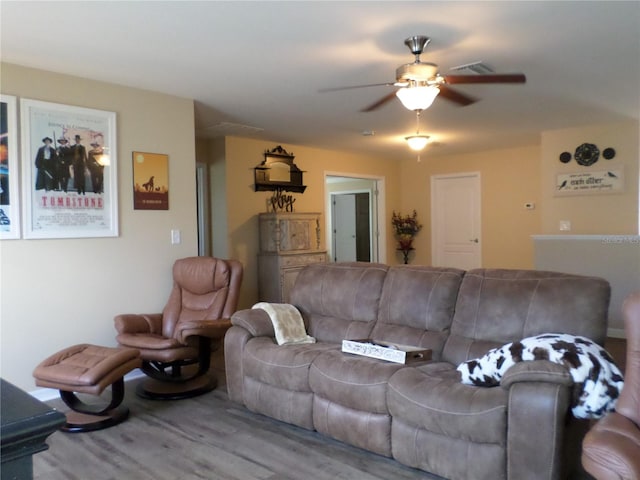 living room with hardwood / wood-style flooring and ceiling fan