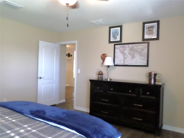 bedroom with ceiling fan and dark hardwood / wood-style flooring