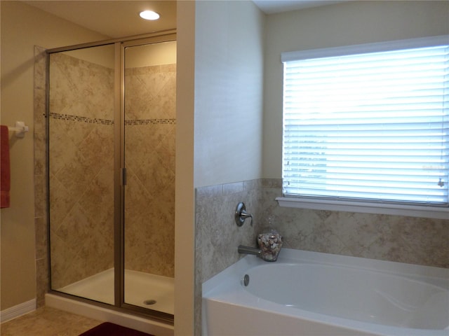 bathroom featuring tile patterned flooring and independent shower and bath