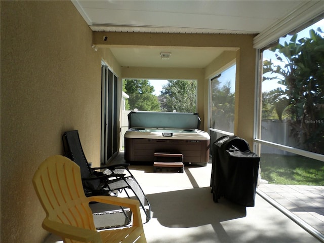 sunroom / solarium with beam ceiling and a healthy amount of sunlight