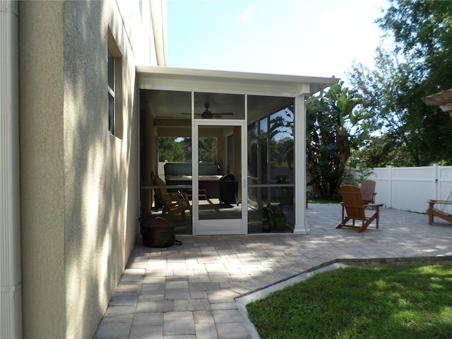 exterior space featuring ceiling fan and a sunroom