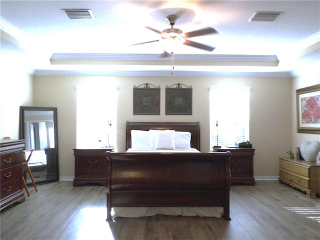 bedroom featuring ceiling fan, crown molding, and hardwood / wood-style flooring