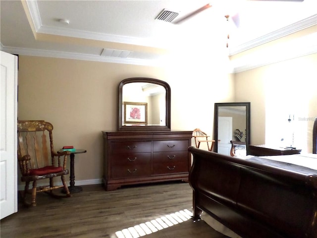 bedroom featuring dark hardwood / wood-style flooring, a raised ceiling, ceiling fan, and crown molding