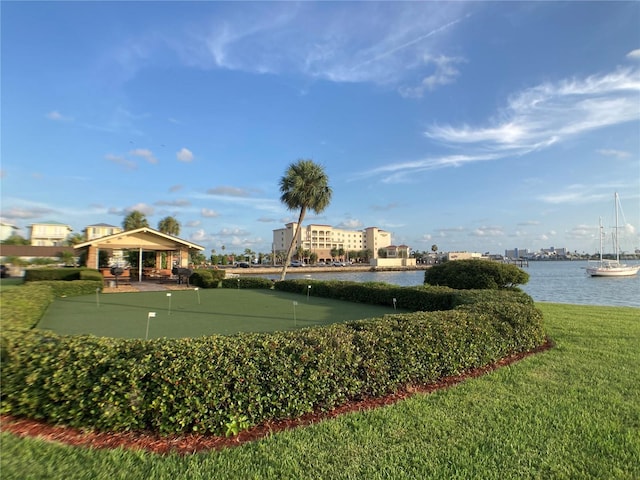 surrounding community featuring a water view and a yard