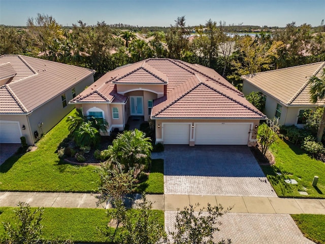 view of front of property featuring a garage and a front lawn