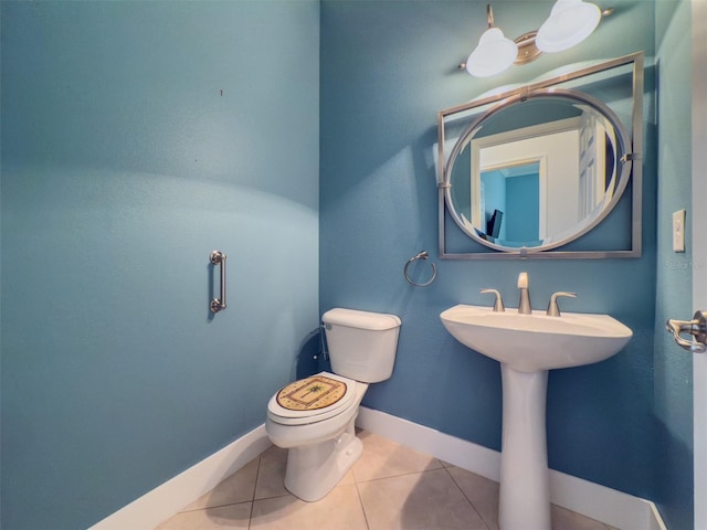 bathroom with sink, tile patterned flooring, and toilet