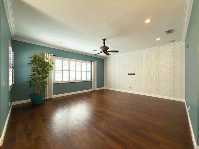 unfurnished room featuring dark hardwood / wood-style floors, ceiling fan, ornamental molding, and a textured ceiling