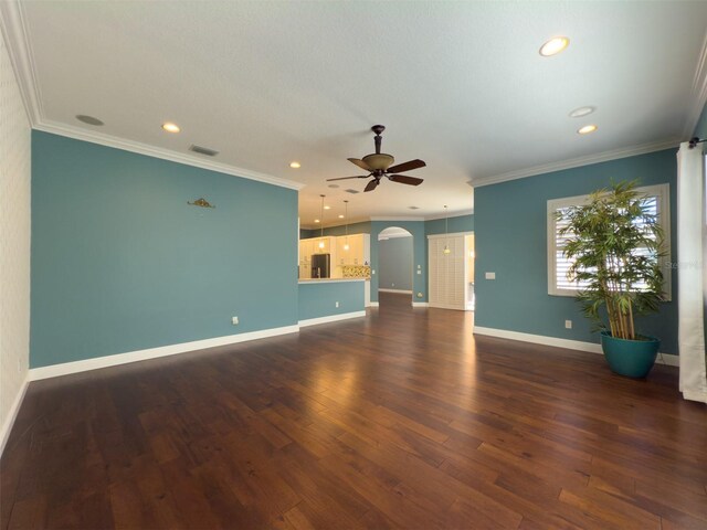 4977 Sapphire Sound Dr, Wimauma, FL 33598 - unfurnished living room with a ceiling fan, dark wood-style floors, arched walkways, ornamental molding, and recessed lighting