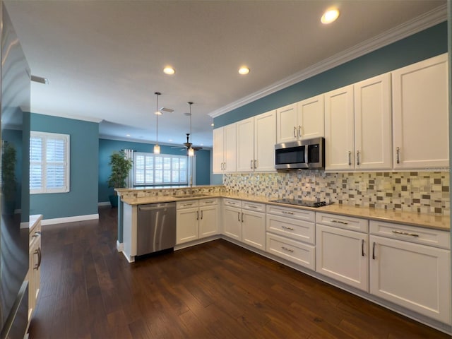 4977 Sapphire Sound Dr, Wimauma, FL 33598 - kitchen with appliances with stainless steel finishes, crown molding, white cabinets, decorative backsplash, and a peninsula