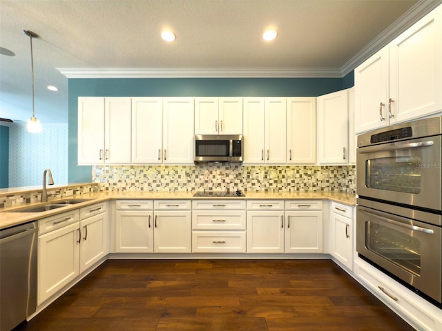 kitchen with white cabinetry, sink, stainless steel appliances, dark hardwood / wood-style flooring, and decorative light fixtures