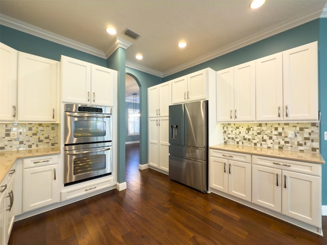 kitchen with white cabinets, stainless steel appliances, and dark hardwood / wood-style floors