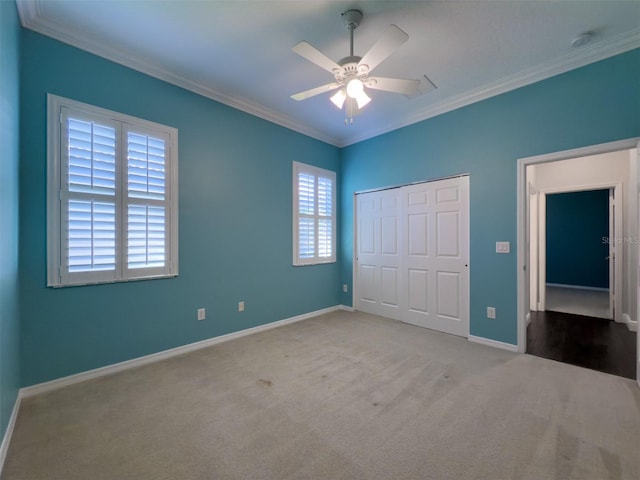 4977 Sapphire Sound Dr, Wimauma, FL 33598 - unfurnished bedroom featuring carpet, ornamental molding, baseboards, a closet, and ceiling fan