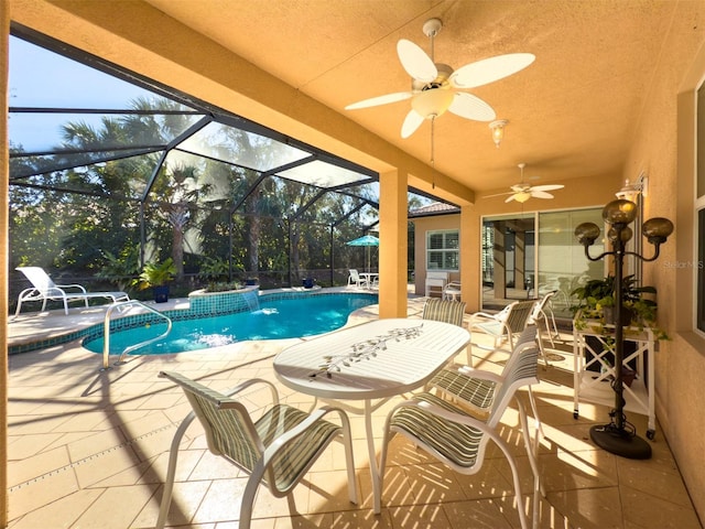 view of swimming pool with pool water feature, ceiling fan, a lanai, and a patio