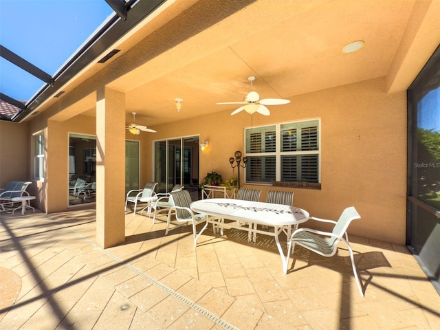 view of patio / terrace with a lanai and ceiling fan