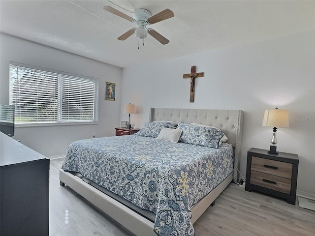 bedroom featuring ceiling fan and hardwood / wood-style flooring