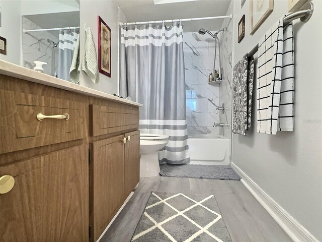 full bathroom featuring vanity, hardwood / wood-style floors, shower / tub combo, and toilet